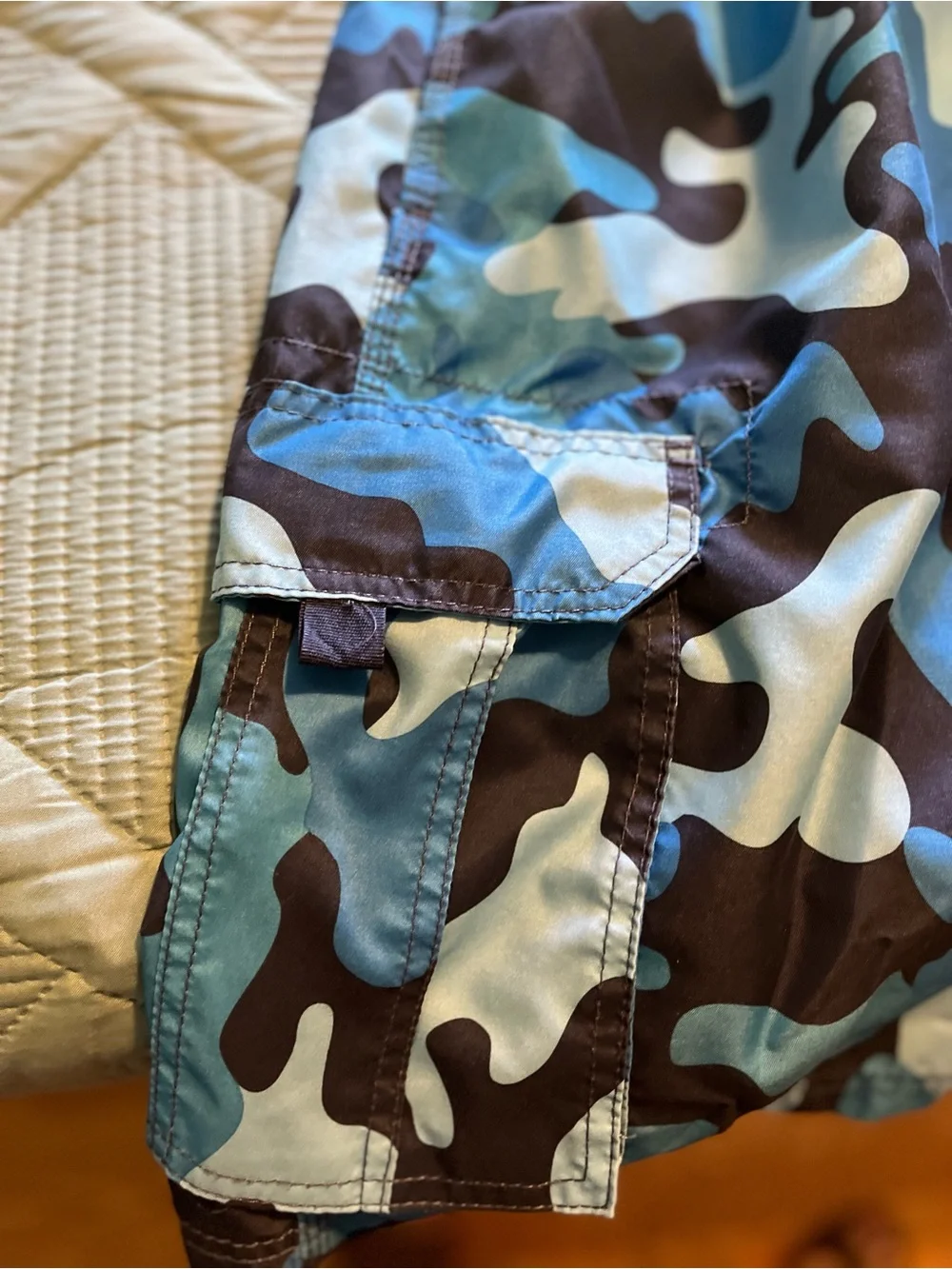Pair of Kanu Surf Men's Blue Camo & Black Floral Swim Trunks